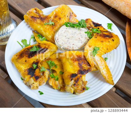 Fried chicken wings with mustard sauce Fried chicken wings with mustard sauce 128893444