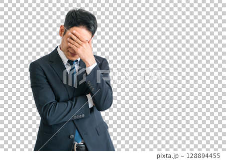 Asian middle-aged businessman in a suit holding his head in shock and stress (troubled, depressed, fatigued, laid off) Asian middle-aged businessman in a suit holding his head in shock and stress (troubled, depressed, fatigued, laid off) 128894455
