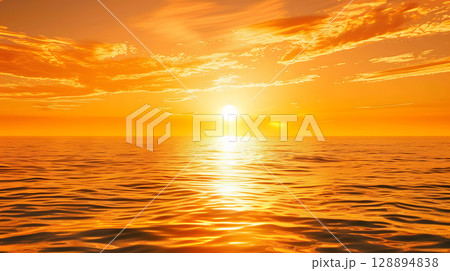 Golden sunset over a vast ocean casting a warm glow 128894838