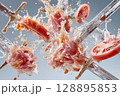 Sliced tomatoes and raw meat collide with swords in dramatic splash of water 128895853