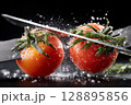 Fresh tomatoes being sliced with dramatic splashes of water and salt on black background 128895856