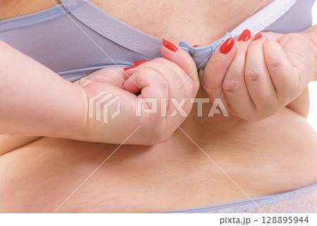 Woman wearing bra. Back view Woman wearing bra. Back view 128895944