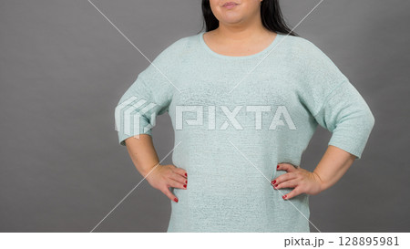Plus size mature woman in jumper 128895981