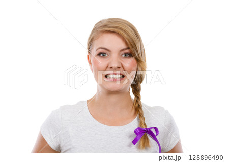 Teenage girl in braid hair making angry face 128896490