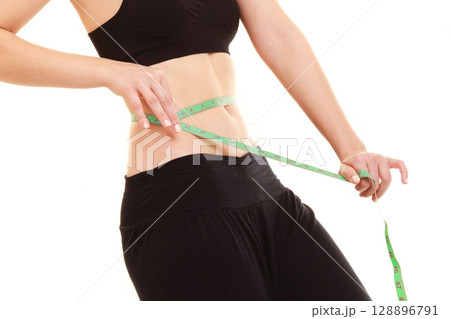 diet. slim fit girl with measure tape measuring waist 128896791