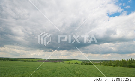 A Beautiful Scenic Cloudy Sky Over Expansive Green Fields Landscape That Is Truly Breathtaking 128897253