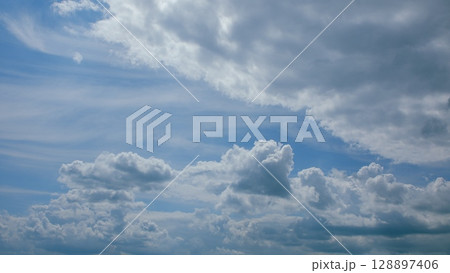 A Beautiful Cloudy Sky Featuring Various, Varying Shades of Blue Across the Horizon 128897406