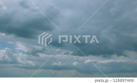 A dramatic sky with clouds creates an artistic atmosphere in natures picturesque backdrop 128897409