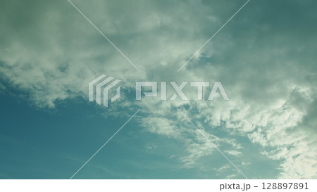 The Beautiful Cloudy Sky is adorned with Soft Hues that create a stunning atmosphere 128897891