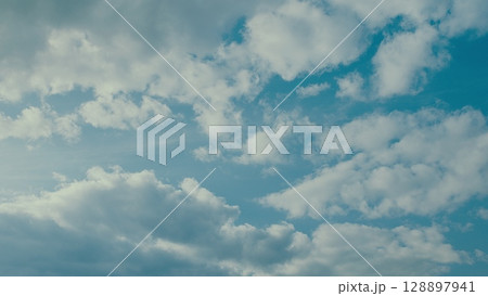 A Beautiful Cloudscape with a Bright Blue Sky creating an enchanting natural atmosphere A Beautiful Cloudscape with a Bright Blue Sky creating an enchanting natural atmosphere 128897941
