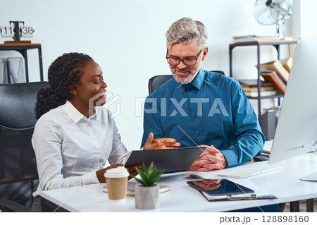Professional Collaboration Between Two Colleagues in a Modern Office Setting 128898160