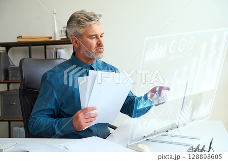 Professional Business Analyst Using Futuristic Technology In Modern Office Professional Business Analyst Using Futuristic Technology In Modern Office 128898605