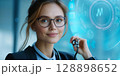 Doctor holding stethoscope with futuristic medical software displaying 128898652