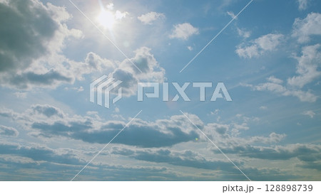A Beautiful Cloudy Sky that features Radiant Sunlight spilling through the clouds 128898739