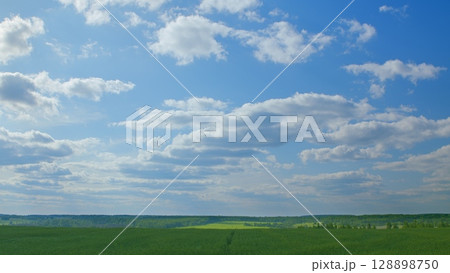 Witnessing Breathtaking Landscapes with a Beautiful Blue Sky and Lush Green Fields 128898750