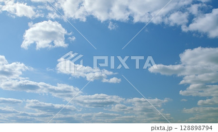 A Beautiful Cloudy Sky Featuring a Clear Blue Background That Evokes Serenity and Peacefulness A Beautiful Cloudy Sky Featuring a Clear Blue Background That Evokes Serenity and Peacefulness 128898794