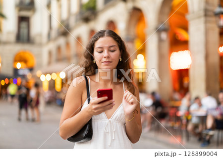 Young woman with phone walking around Barcelona Young woman with phone walking around Barcelona 128899004
