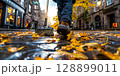Street cleaner sweeping autumn leaves in edinburgh old town 128899011