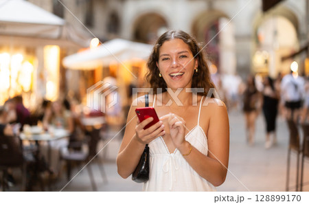 Young woman with phone walking around Barcelona Young woman with phone walking around Barcelona 128899170