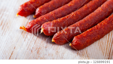 Tyrolean sausages and peppercorns on wooden table Tyrolean sausages and peppercorns on wooden table 128899191