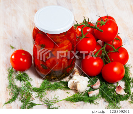 Pickled tomatoes in glass jar Pickled tomatoes in glass jar 128899261