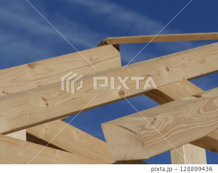 The wooden roof is made of wood and has a blue sky in the background The wooden roof is made of wood and has a blue sky in the background 128899436