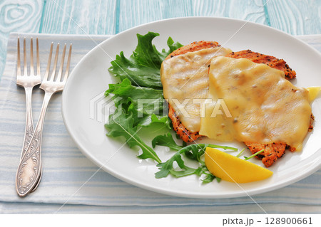 grilled chicken breast topped with melted cheese grilled chicken breast topped with melted cheese 128900661