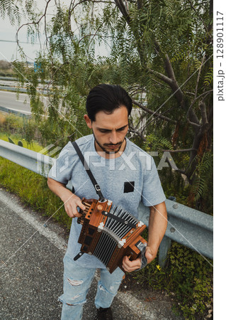 Man Performing A Musical Song With Accordion Man Performing A Musical Song With Accordion 128901117