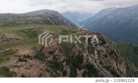 Off road vehicle conquering mountain pass, breathtaking aerial view of wilderness adventure 128901229
