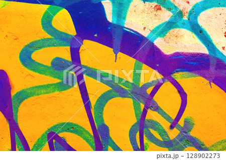 Vibrant Graffiti Swirls on Bold Yellow Wall for Funky 90s Urban Art Vibrant Graffiti Swirls on Bold Yellow Wall for Funky 90s Urban Art 128902273