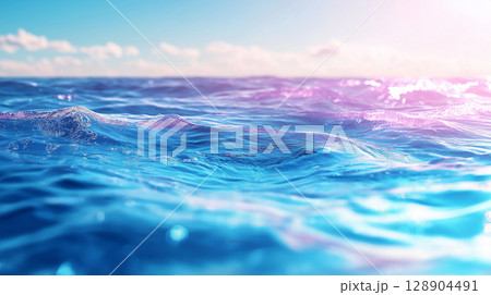 Vibrant ocean waves under bright sky with soft clouds 128904491