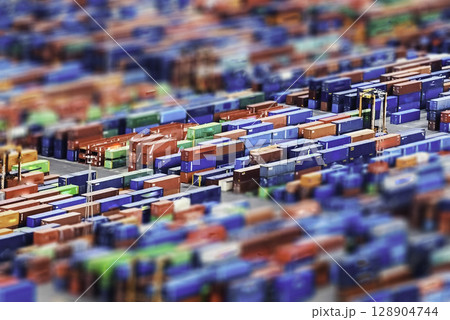 Aerial view over shipping containers stacked on a commercial port 128904744