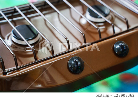 A new compact brown gas stove. 128905362