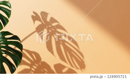 Shadow of a tropical plant cast against a beige wall, evoking warmth and simplicity with a natural look. Generative AI. 128905721