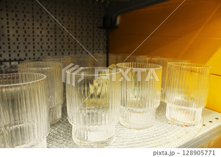 transparent glasses on the store shelf. Glassware. transparent glasses on the store shelf. Glassware. 128905771