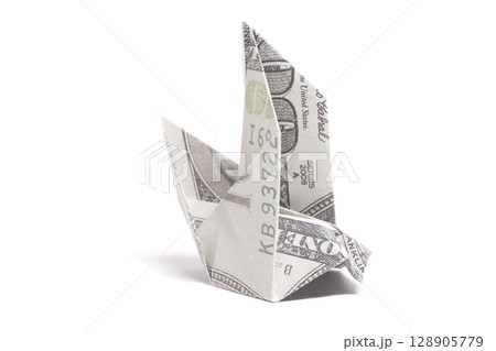 Origami Bird made from a hundred-dollar bill on a white background. Origami Bird made from a hundred-dollar bill on a white background. 128905779