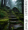 Moss-Covered Mountain Staircase Leading into Fog and Shadowed Forest from a Low Angle View 128905802