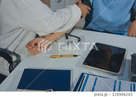 Doctor checking patient arterial blood pressure in hospital. Health care Concept 128906283