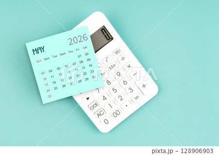May 2026 calendar card with calculator on blue color background. 128906903