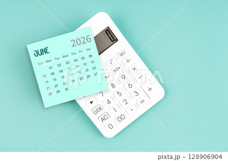 June 2026 calendar card with calculator on blue color background. June 2026 calendar card with calculator on blue color background. 128906904