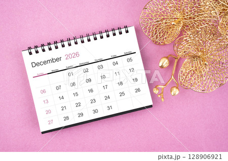 December 2026 desk calendar with golden orchid on pink color background. December 2026 desk calendar with golden orchid on pink color background. 128906921