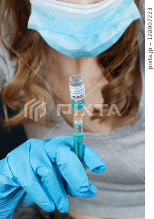 Coronavirus vaccine on syringe 128907223