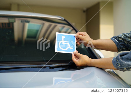 Wheelchair sticker sign on car for safety travel. 128907556