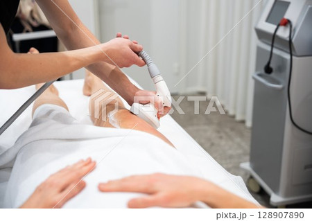Laser hair removal session at a professional clinic for smooth skin Laser hair removal session at a professional clinic for smooth skin 128907890