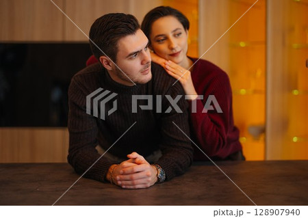 Couple enjoying a moment together in a cozy indoor setting Couple enjoying a moment together in a cozy indoor setting 128907940