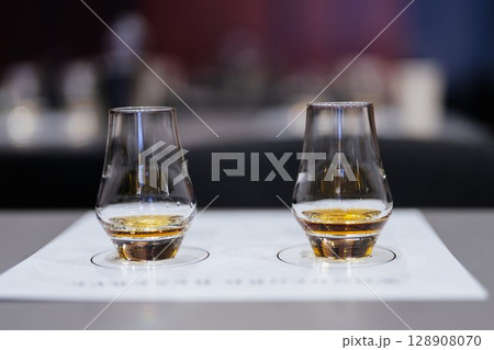 Savoring distinct flavors in a whiskey tasting experience at sunset Savoring distinct flavors in a whiskey tasting experience at sunset 128908070