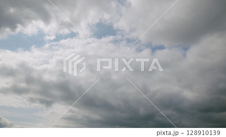 A dynamic and beautiful cloudy sky adorned with subtle patches of deep and calming blue hues A dynamic and beautiful cloudy sky adorned with subtle patches of deep and calming blue hues 128910139