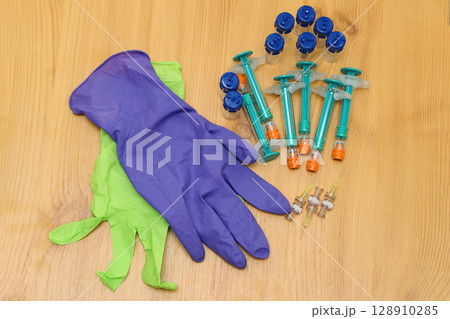 Gloves with vials and injections 128910285