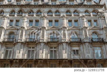 London victorian architectural of Wrought iron black railings balconies and Classic glass windows in residential tenement buildings. London victorian architectural of Wrought iron black railings balconies and Classic glass windows in residential tenement buildings. 128911739