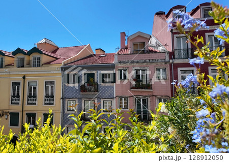 Colorful European Buildings Framed by Greenery Under a Bright Blue Sky Colorful European Buildings Framed by Greenery Under a Bright Blue Sky 128912050